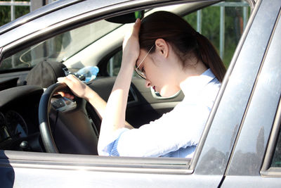 Full length of woman sitting in car