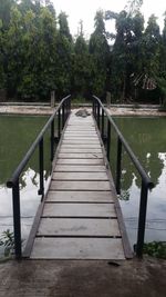 Footbridge amidst trees in park