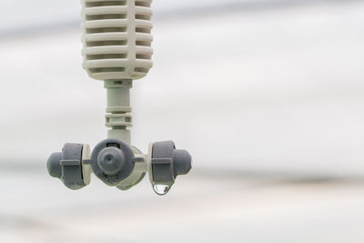 Close-up of coin-operated binoculars against sky