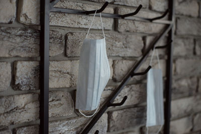 Close-up of clothes drying against white wall