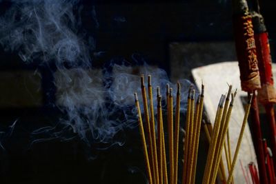 Close-up of incense sticks burning in temple