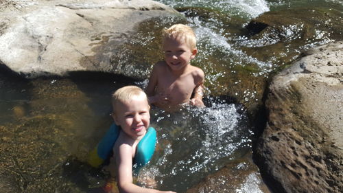 High angle view of shirtless boy in water