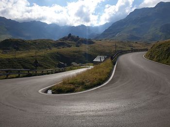 Road passing through mountains against sky