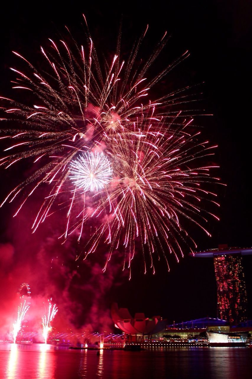 firework display, night, illuminated, exploding, celebration, firework - man made object, arts culture and entertainment, long exposure, event, motion, sparks, firework, entertainment, glowing, sky, multi colored, blurred motion, water, celebration event, low angle view