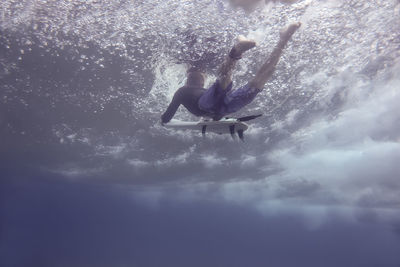 Full length of man surfing underwater in sea