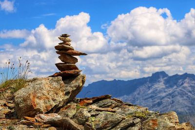 Stack of rocks on mountain against sky