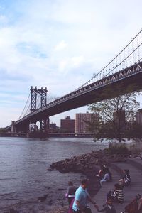 Bridge over river with city in background