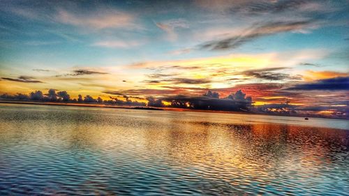 Scenic view of dramatic sky over sea during sunset