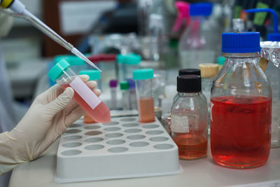 Cropped hands testing chemicals in laboratory