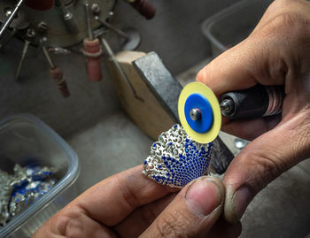 Close-up of hand making jewelry