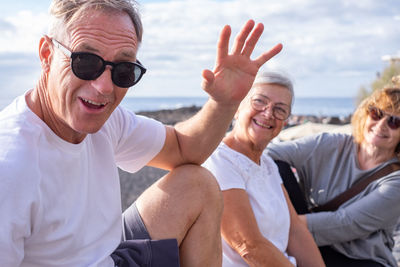 Portrait of smiling friends sitting on terrace