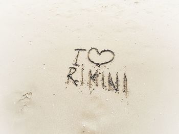 High angle view of text on sand at beach