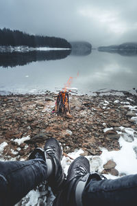 Low section of person in lake during winter