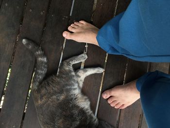 Low section of man holding hands on wood