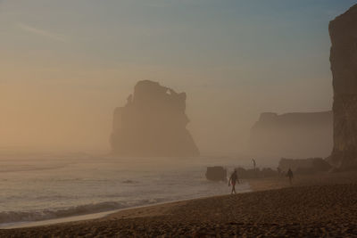 Silhouette of people on beach