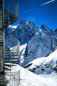 Snow covered mountain against clear blue sky