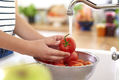 Midsection of man preparing food in kitchen at home