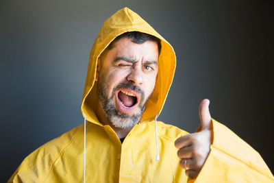 Portrait of man wearing mask against gray background