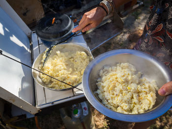 High angle view of scrambled ostrich egg in cooking pan on camping stove