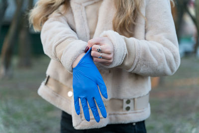 Midsection of woman holding umbrella