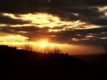 Silhouette landscape against sky during sunset