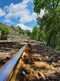 Surface level of railroad track against sky