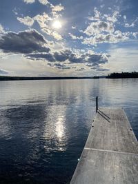 Pier over lake against sky