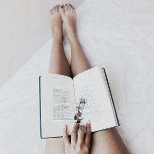 Open book on female legs