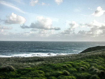 Scenic view of sea against cloudy sky