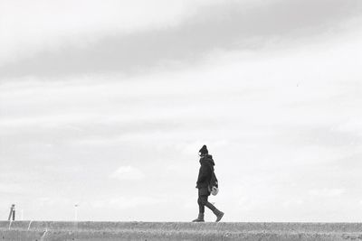 Full length of woman standing against sky