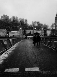 Woman standing on bridge