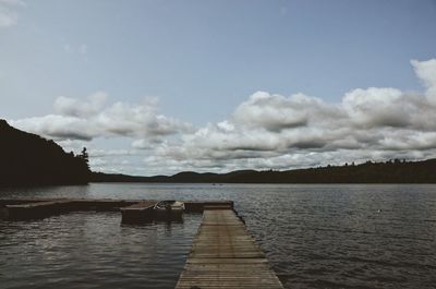 Pier over lake against sky