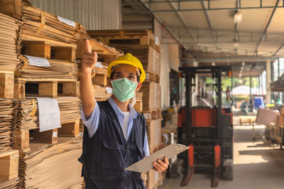 Rear view of man standing in factory