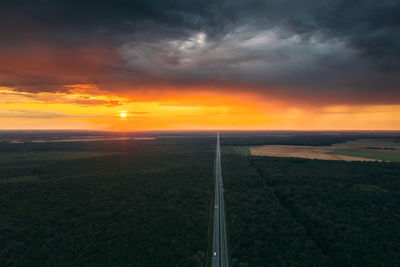 Scenic view of field against sky during sunset