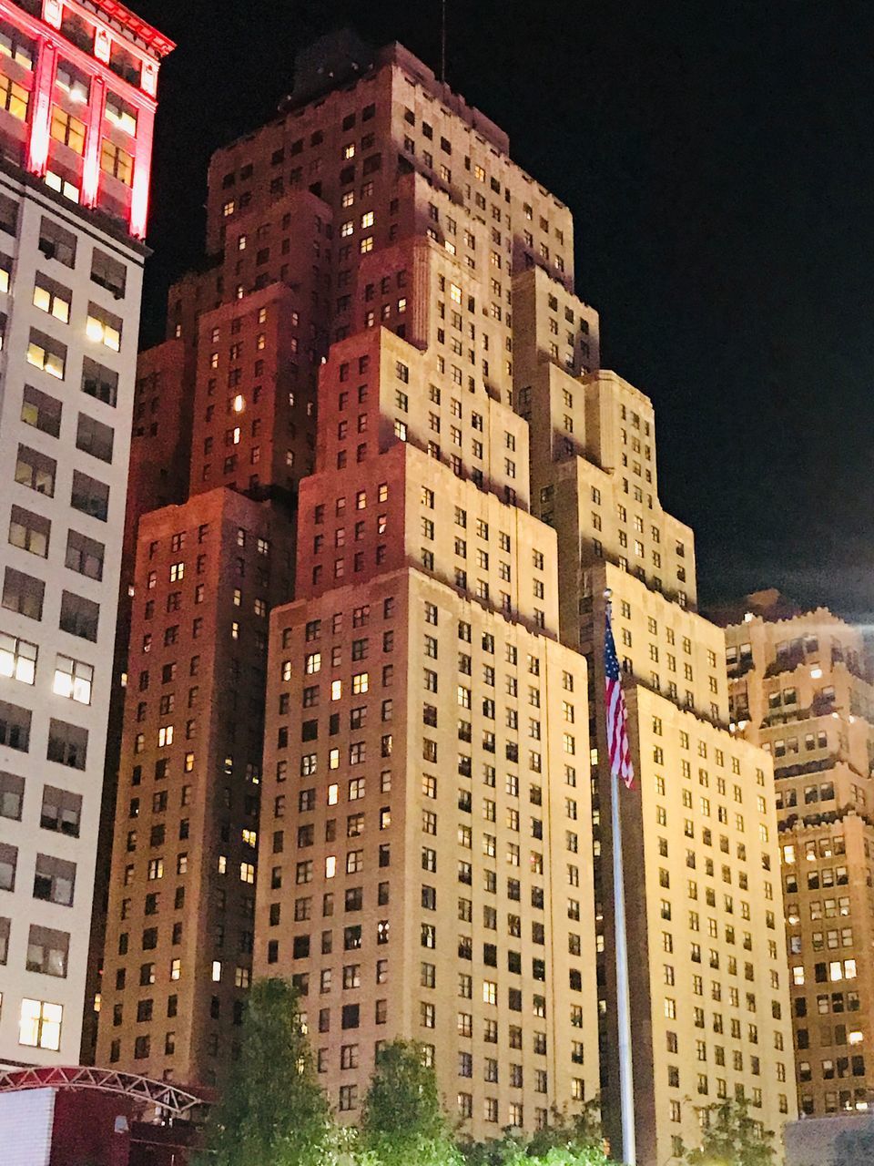 LOW ANGLE VIEW OF BUILDINGS AGAINST SKY AT NIGHT