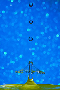 Low angle view of water falling from illuminated metal