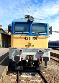 Train on railroad tracks against sky