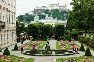 Group of people in park against buildings