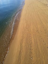 High angle view of footprints on beach