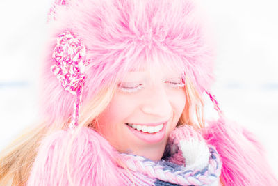 Portrait of young woman with pink hair against sky