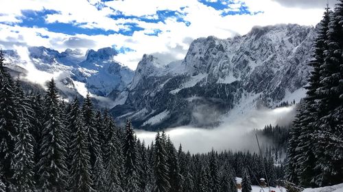 Scenic view of snow covered mountains against sky