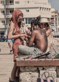 Friends sitting in city