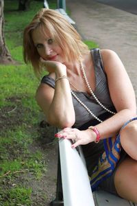 Portrait of smiling senior woman sitting in park