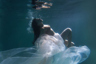 Low section of woman swimming in sea