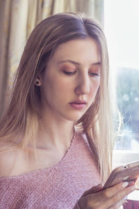 Portrait of young woman using mobile phone