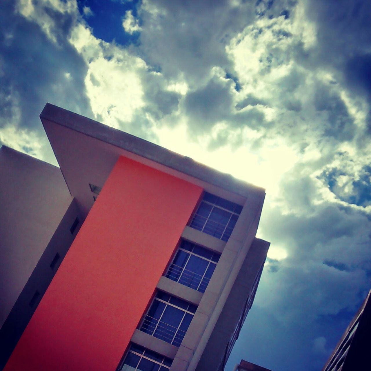 building exterior, architecture, built structure, low angle view, sky, cloud - sky, cloud, window, cloudy, building, residential structure, outdoors, residential building, day, city, no people, blue, house, high section, tower