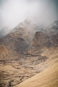 Scenic view of arid landscape against sky