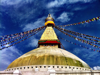 Low angle view of temple against cloudy sky