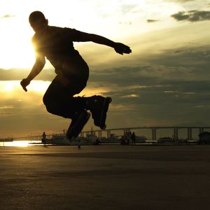 Full length of silhouette man inline skating