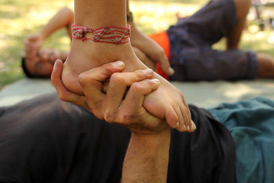 Low section of couple holding hands